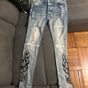 AMIRI Light Blue Skinny Jeans with Black Flame Design